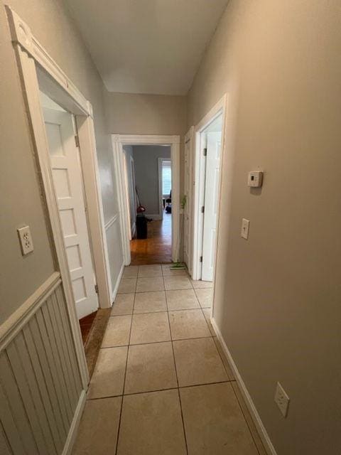 hall with light tile patterned flooring