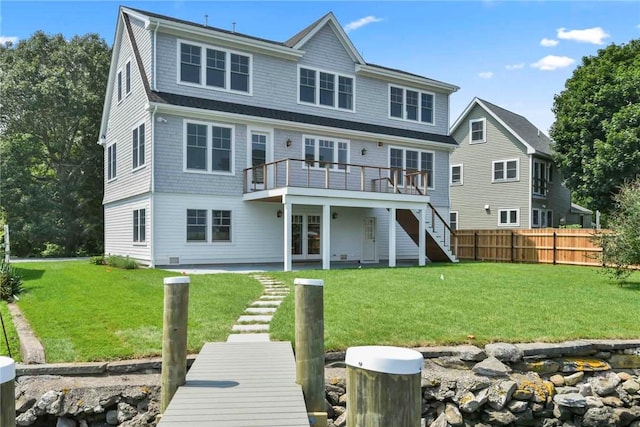 rear view of property featuring french doors, a yard, a patio area, and a wooden deck