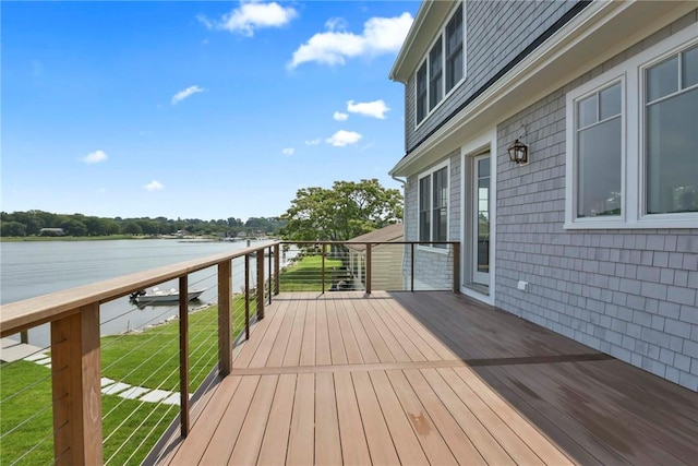 wooden terrace featuring a yard and a water view