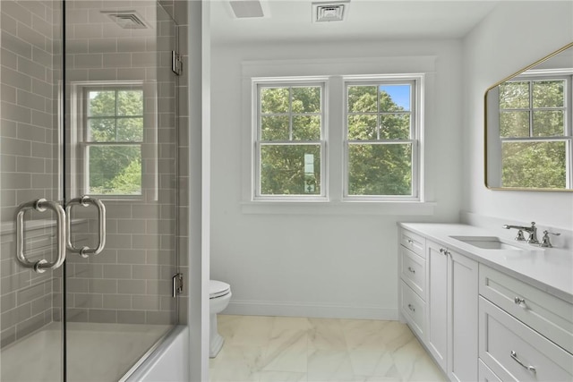 bathroom with vanity, toilet, and an enclosed shower