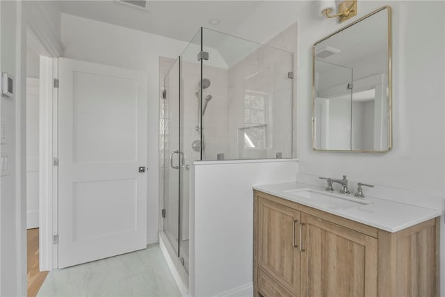 bathroom with vanity and a shower with shower door