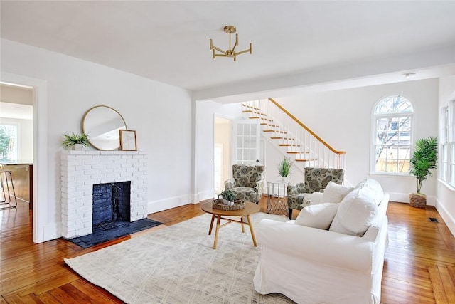 living room featuring hardwood / wood-style floors and a brick fireplace