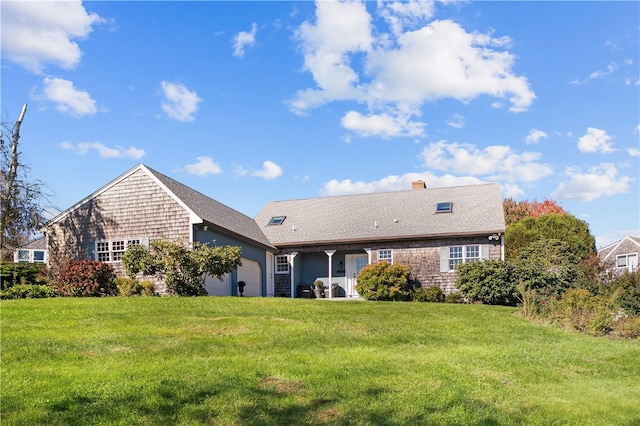 rear view of house with a lawn and a garage