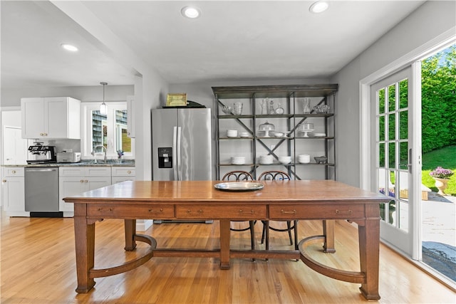 dining room with sink and light hardwood / wood-style flooring