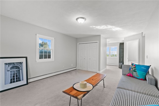 carpeted living room featuring baseboard heating