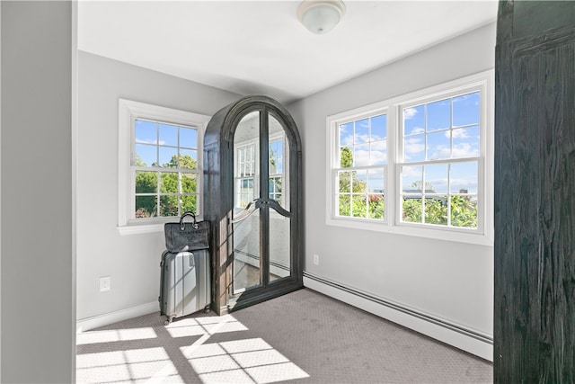 entryway with light colored carpet and a baseboard radiator