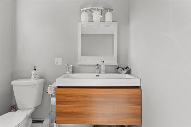 bathroom with toilet, vanity, and a baseboard radiator