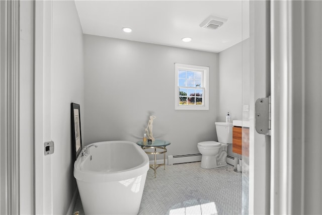 bathroom featuring toilet, tile patterned floors, baseboard heating, and a bath