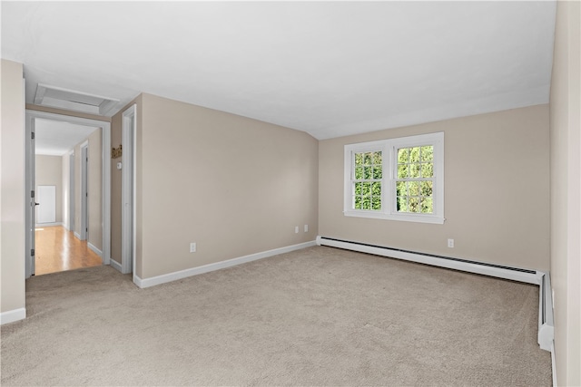 empty room with light colored carpet and a baseboard heating unit