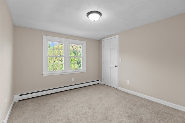 empty room with baseboard heating and light colored carpet