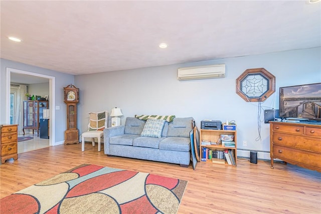 living room featuring a wall mounted air conditioner, light hardwood / wood-style flooring, and a baseboard heating unit