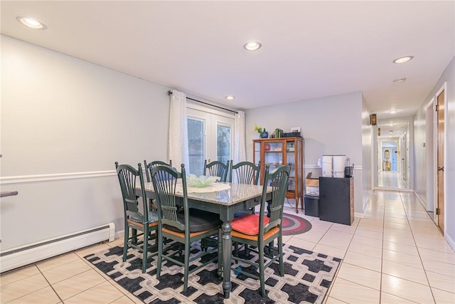 dining room featuring light tile patterned floors, french doors, and a baseboard radiator