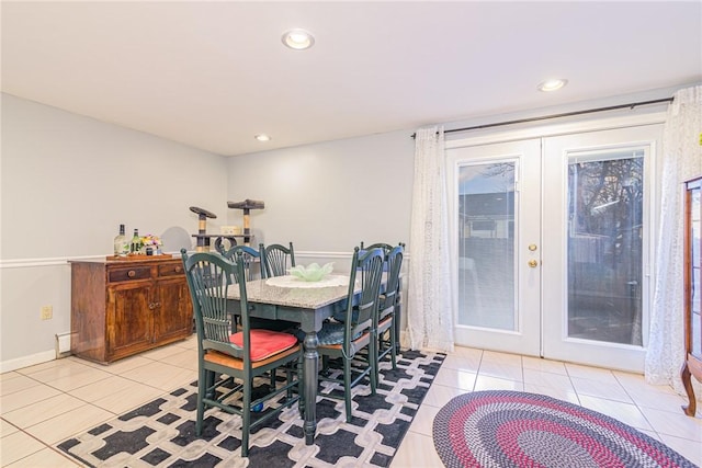 dining area featuring french doors and light tile patterned floors