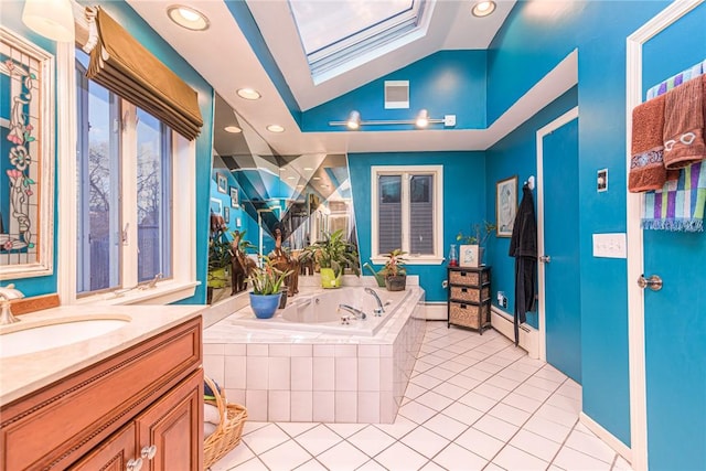 bathroom featuring tile patterned flooring, vanity, lofted ceiling with skylight, and tiled tub