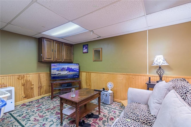 living room featuring a paneled ceiling