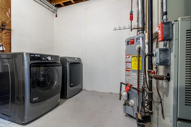 washroom with washing machine and dryer, heating unit, and gas water heater