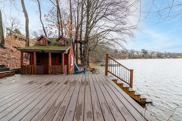 wooden deck featuring a grill and a water view