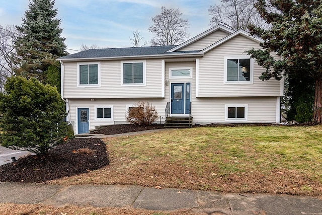 split foyer home featuring a front lawn