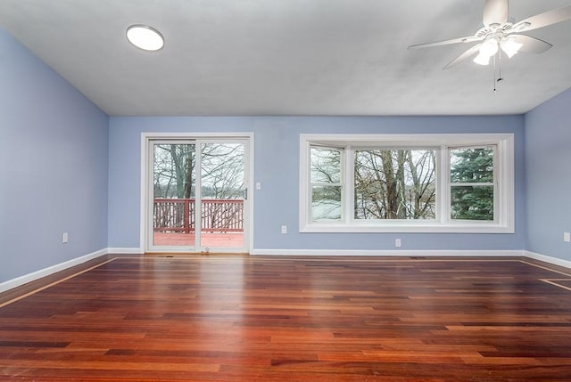 empty room with dark hardwood / wood-style floors and ceiling fan