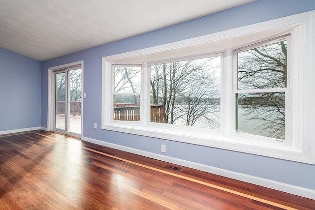 spare room with dark wood-type flooring