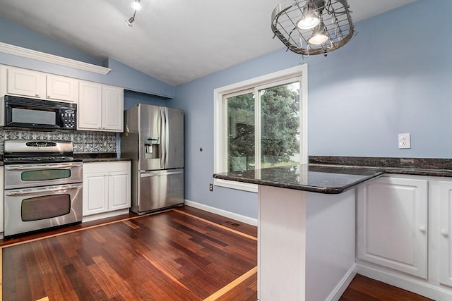 kitchen with appliances with stainless steel finishes, dark hardwood / wood-style floors, white cabinetry, and lofted ceiling