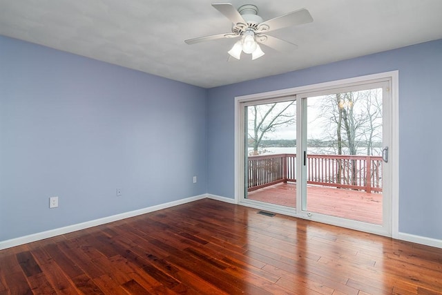 unfurnished room featuring ceiling fan and dark wood-type flooring