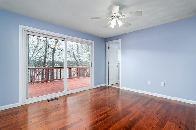 unfurnished room featuring ceiling fan and dark wood-type flooring