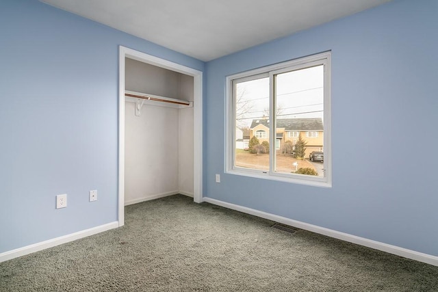 unfurnished bedroom with a closet and carpet