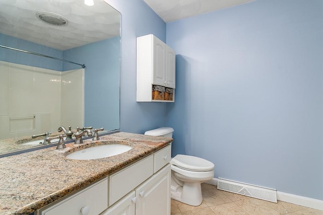 bathroom featuring tile patterned floors, vanity, toilet, and walk in shower