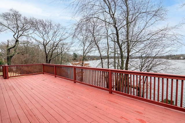 wooden terrace featuring a water view