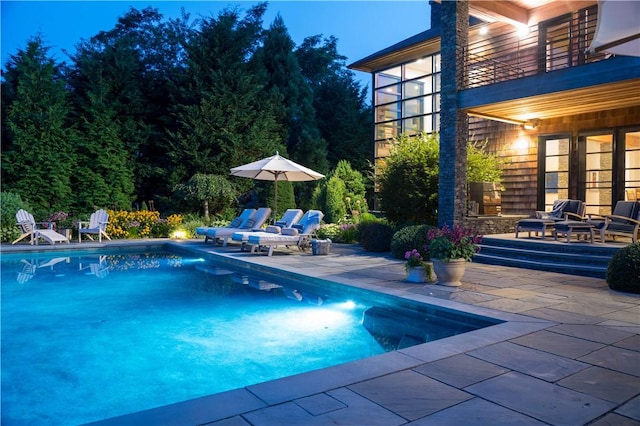 outdoor pool featuring a patio