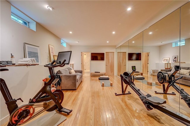 workout area featuring recessed lighting and light wood-style floors