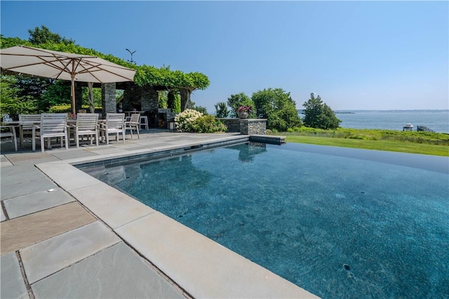 view of swimming pool with a patio and a water view