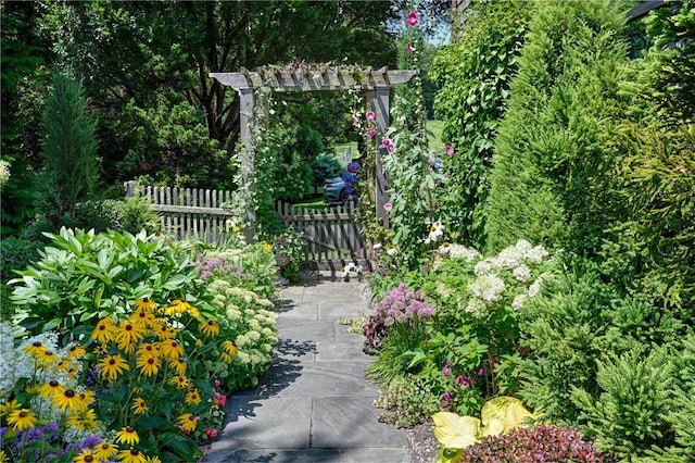 surrounding community with fence and a pergola