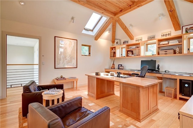 home office with lofted ceiling with skylight and light wood-style floors