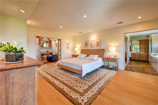 bedroom with wood finished floors, visible vents, and recessed lighting