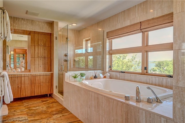 bathroom with a shower stall, visible vents, a bath, and vanity