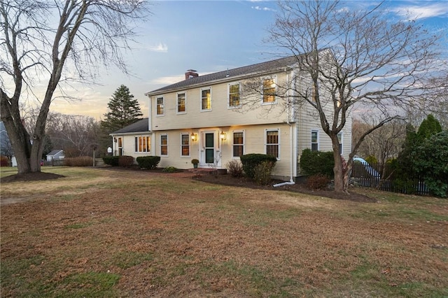 colonial home featuring a lawn