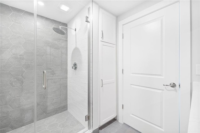 bathroom with tile patterned flooring and walk in shower