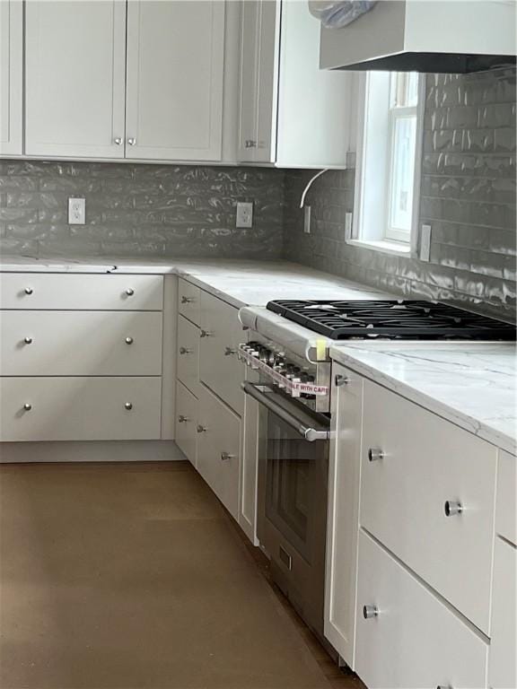 15 Cora St, East Greenwich, RI 02818 - kitchen with high end stainless steel range oven, white cabinetry, and decorative backsplash