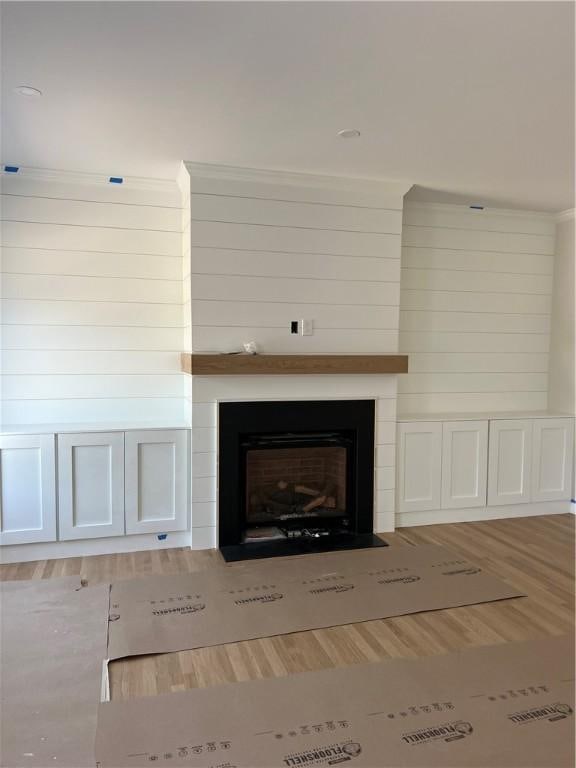 15 Cora St, East Greenwich, RI 02818 - detailed view of wood finished floors and a fireplace with flush hearth