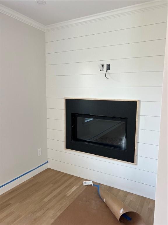 15 Cora St, East Greenwich, RI 02818 - detailed view of wood finished floors, a glass covered fireplace, ornamental molding, and baseboards