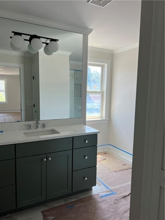 15 Cora St, East Greenwich, RI 02818 - bathroom featuring healthy amount of natural light, ornamental molding, vanity, and baseboards