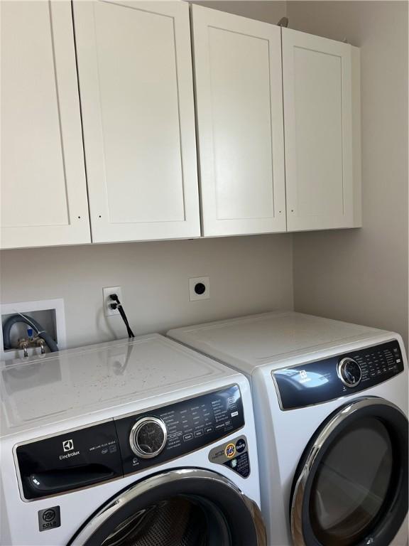 15 Cora St, East Greenwich, RI 02818 - clothes washing area featuring washer and dryer and cabinet space