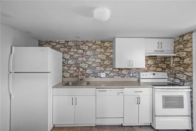 kitchen featuring sink, white cabinets, and white appliances