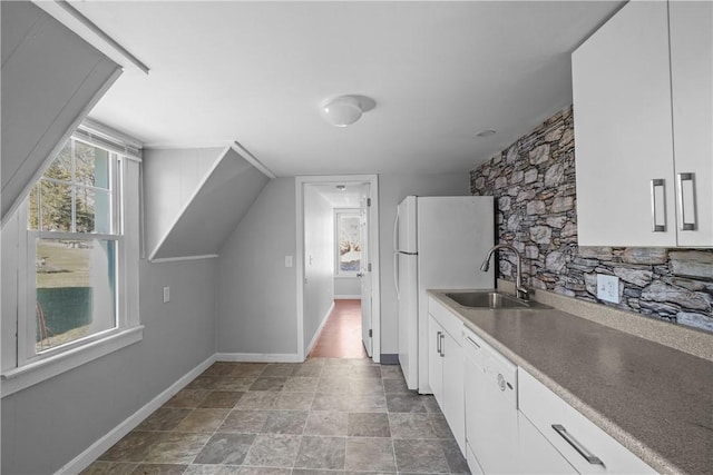 kitchen featuring white cabinetry, sink, and white appliances