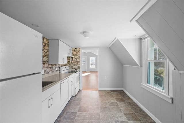 kitchen with white cabinets and white appliances