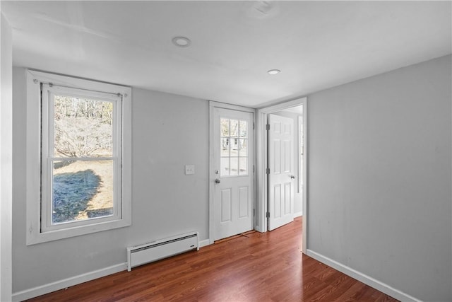 foyer with hardwood / wood-style flooring and a baseboard radiator