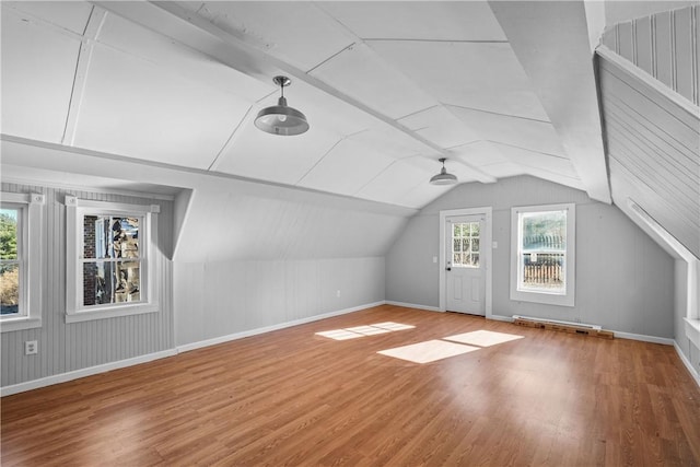 bonus room with wood-type flooring and lofted ceiling