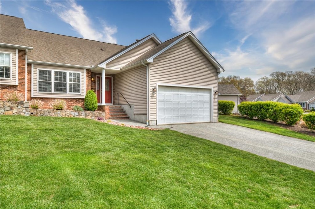 view of front of home with a front lawn and a garage